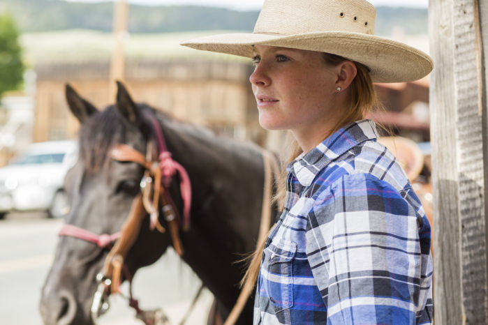 Mariah Fredrickson waits with her horse Oakley